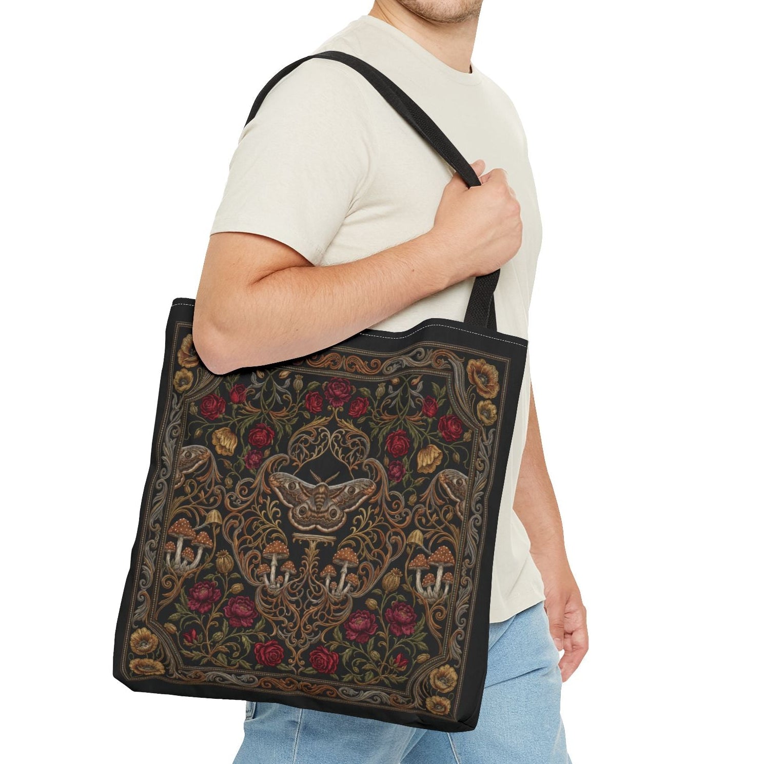 Man holding a decorative tote bag with floral patterns on a white background