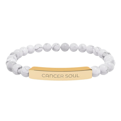 Bracelet with white beads and gold tag reading 'Lovely Leitrim' on a white background
