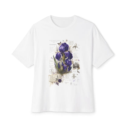 A white short-sleeve crewneck t-shirt featuring a vintage-style botanical print of purple irises, green leaves, and antique-style script on the front, displayed against a solid white background.
