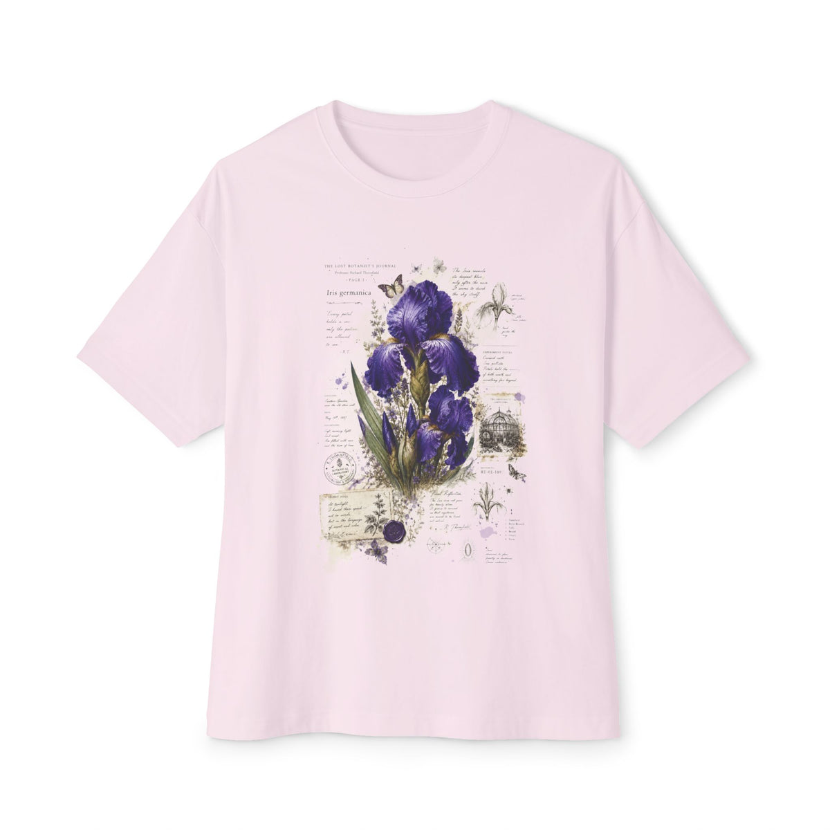 A light pink short-sleeve crewneck t-shirt featuring a vintage-style botanical print of purple irises on the front, displayed against a clean white background.