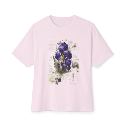 A light pink short-sleeve crewneck t-shirt featuring a vintage-style botanical print of purple irises on the front, displayed against a clean white background.