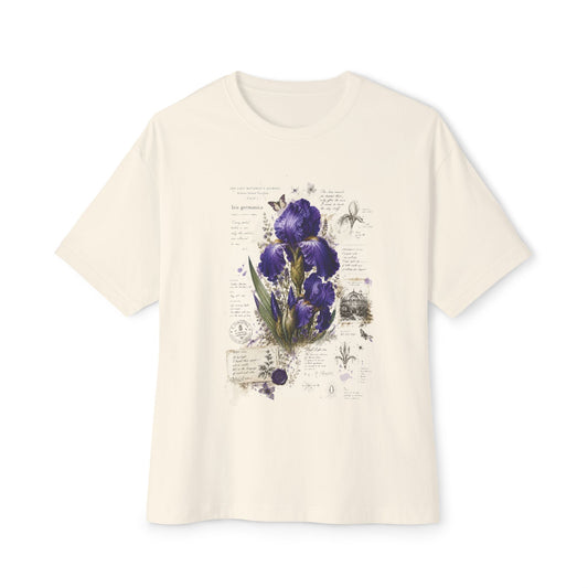 An off-white short-sleeve crewneck t-shirt featuring a central graphic print of purple irises on a vintage-style botanical page with script text.