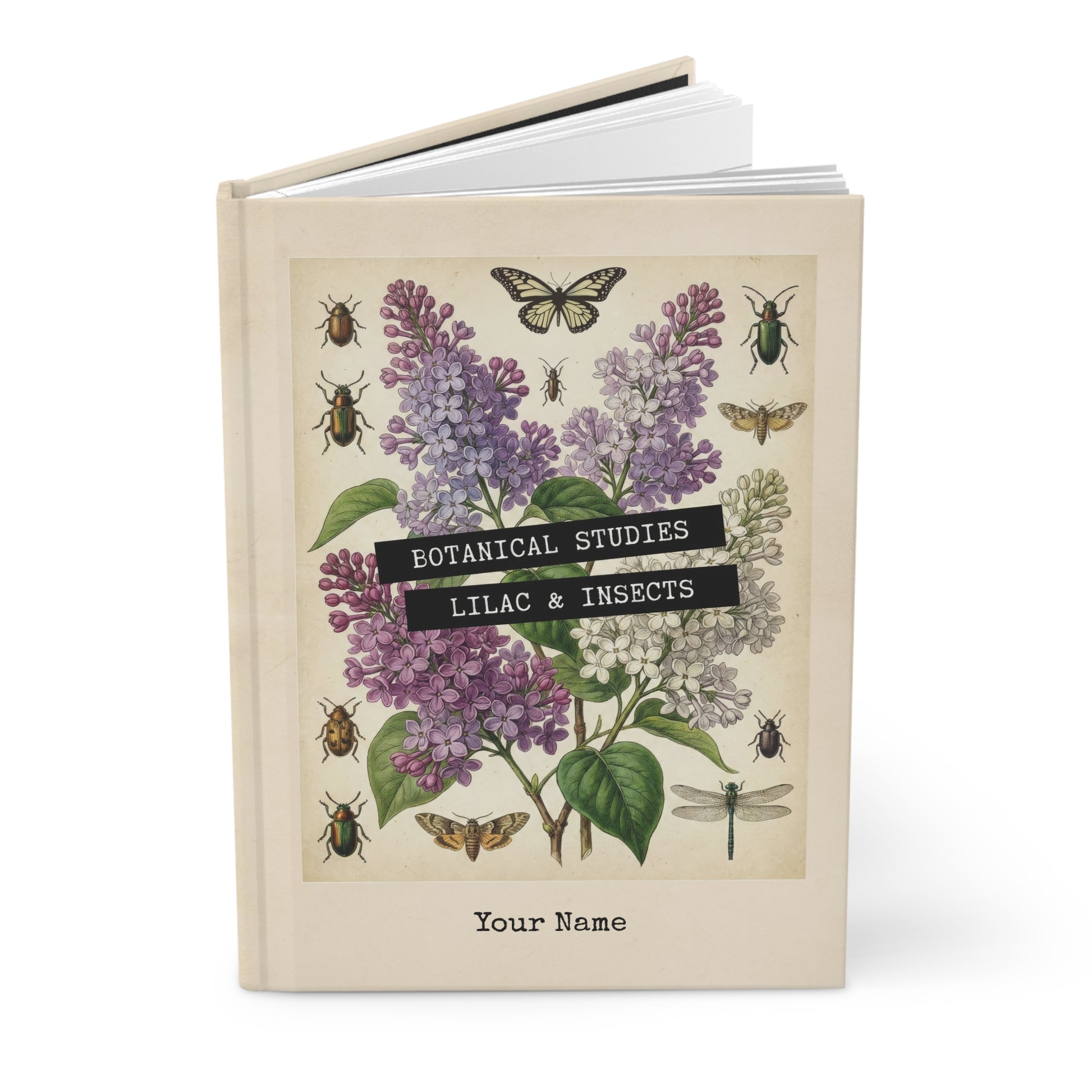 Book with botanical design featuring lilacs and insects on a beige background