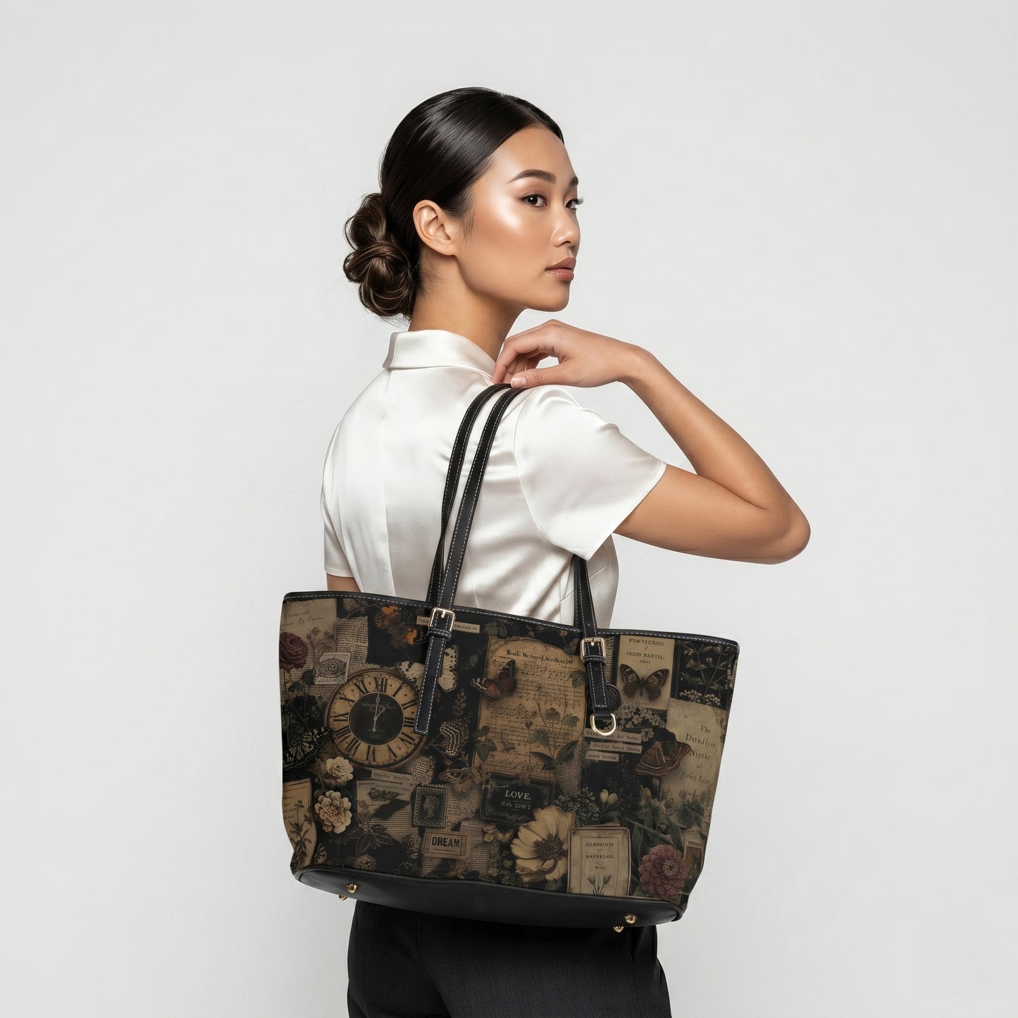 Woman holding a decorative tote bag against a plain background
