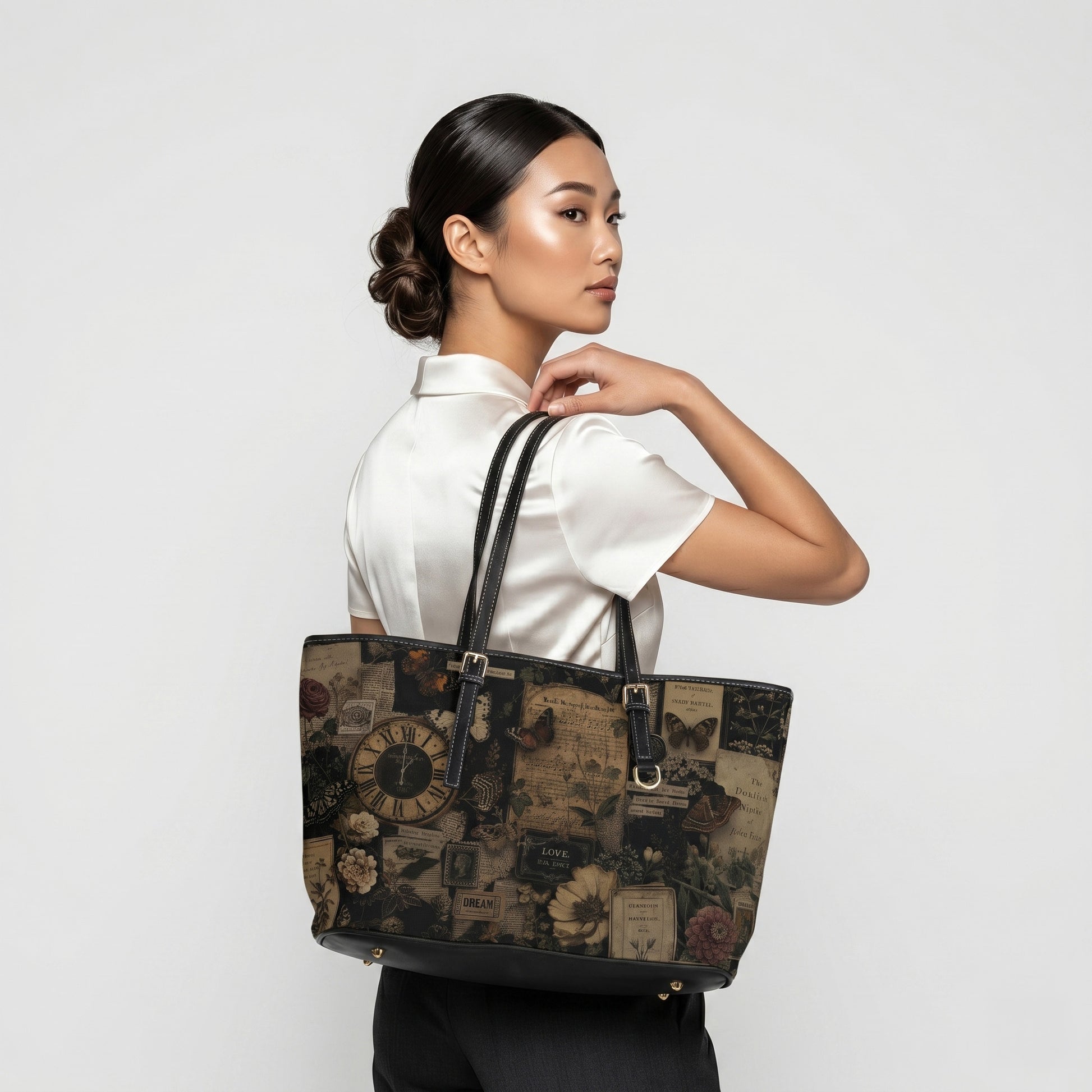 Woman holding a decorative tote bag against a plain background