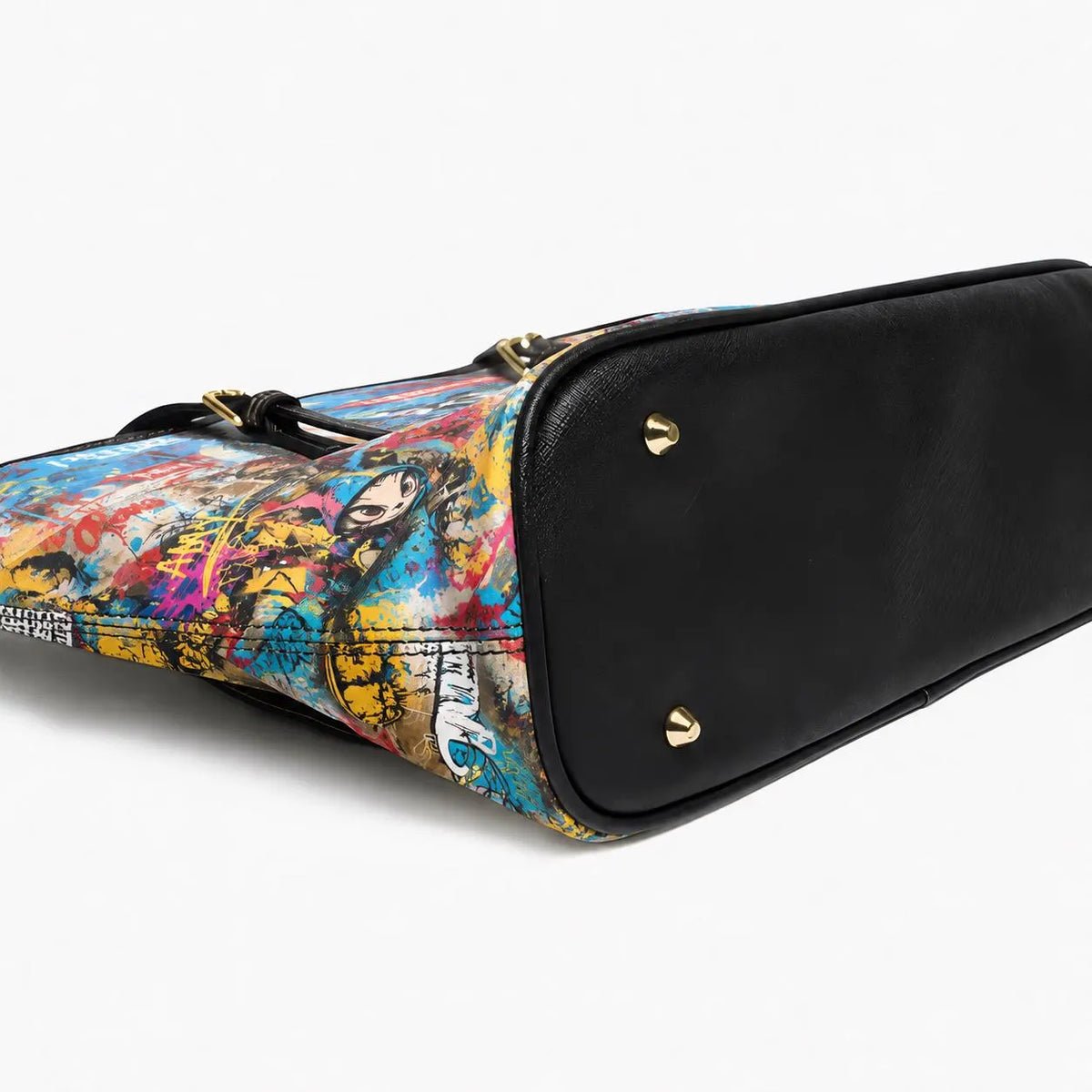 A black leather shoulder bag with a colorful graffiti-style printed canvas side panel, shown on a clean white background.
