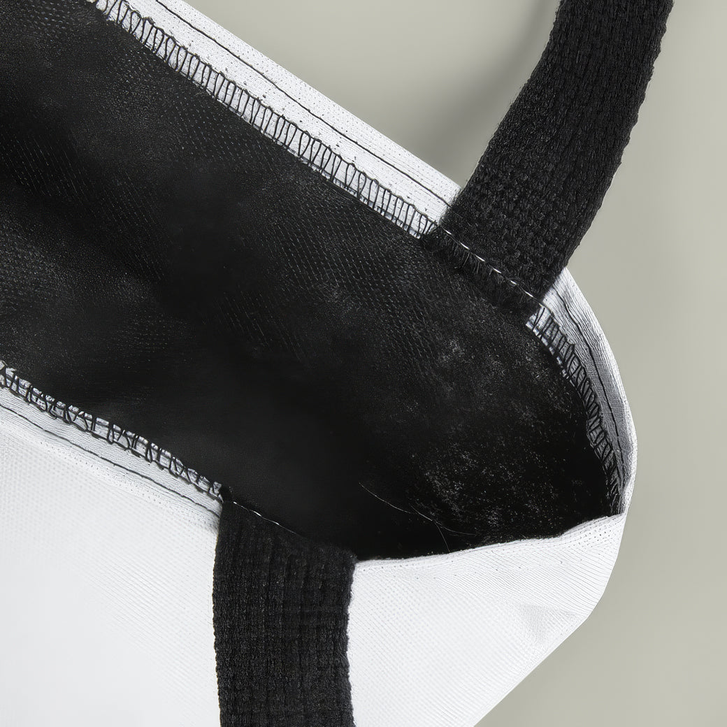 Close-up of a black and white fabric product with a textured handle.