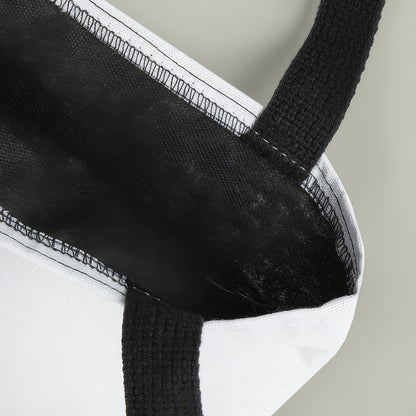 Close-up of a black and white fabric product with a textured handle.
